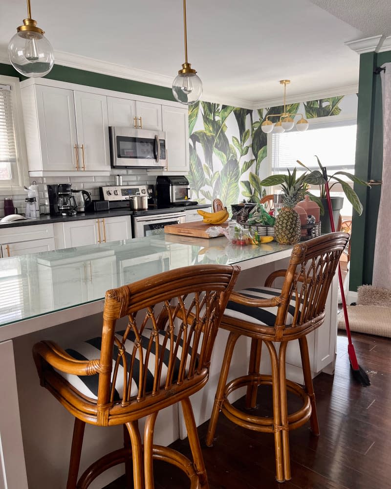 Botanical wallpaper in kitchen with faux marble countertops