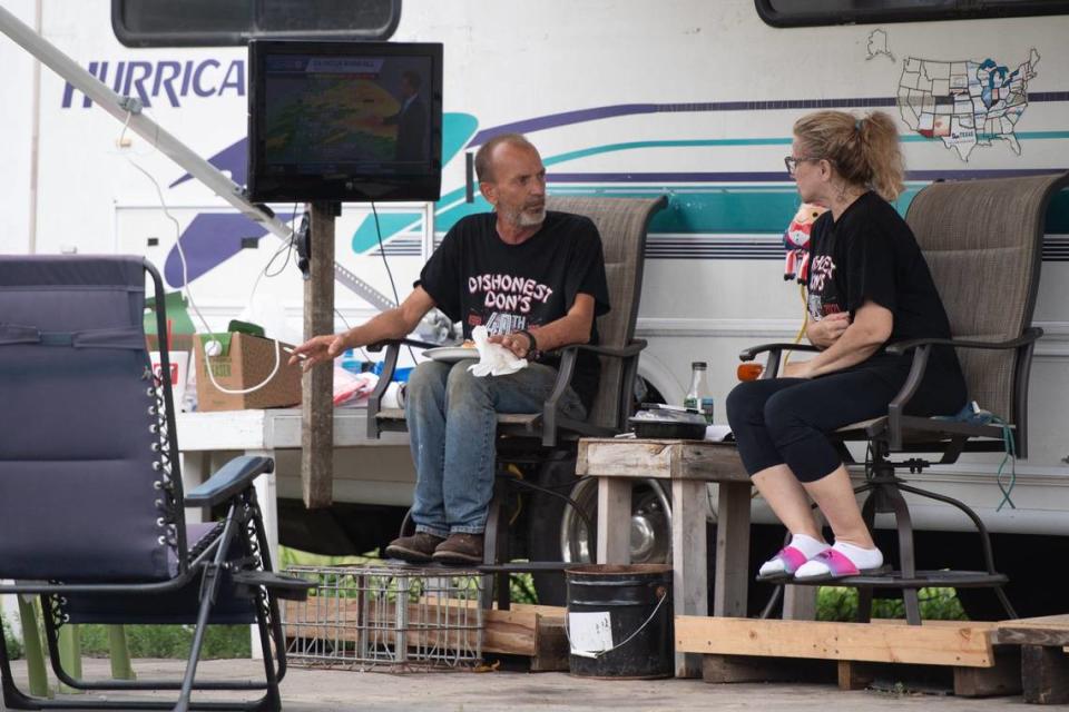 Kurt and Stephanie Eckard rest and monitor the weather as Dishonest Don’s Fireworks prepares to open for business on Wednesday after their tent collapsed on Tuesday night.