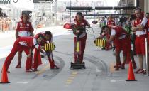 Pit crew wait for Ferrari Formula One driver Felipe Massa of Brazil during the third practice session of the Korean F1 Grand Prix at the Korea International Circuit in Yeongam, October 5, 2013. REUTERS/Lee Jae-Won (SOUTH KOREA - Tags: SPORT MOTORSPORT F1 TPX IMAGES OF THE DAY)