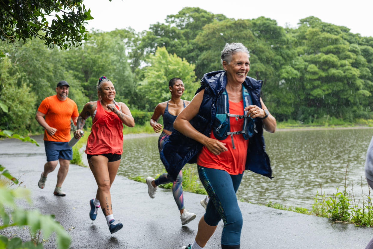 Runners taking part in a community fun run in the rain in Leazes Park in Newcastle upon Tyne, North East England. They are smiling as they run and follow each other on a path. The race is open to people of all ages and abilities and is also dog friendly. 

These files have similar videos/images available.