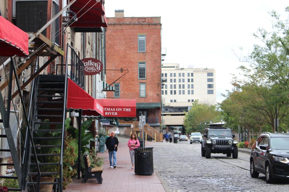 People and cars on River Street after Hurricane Ian tracked further east, missing the Georgia coast and making landfall in South Carolina instead.