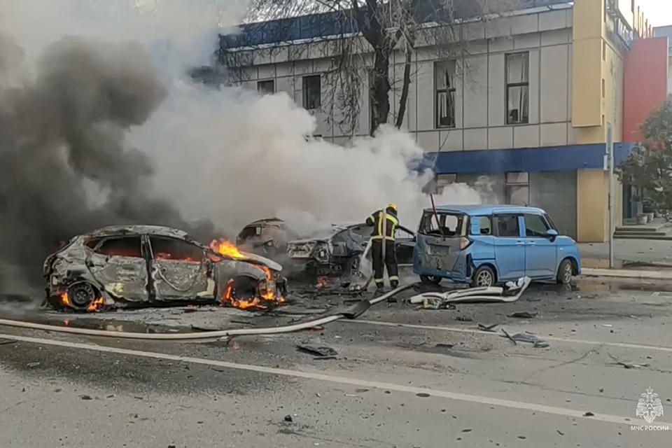 FILE - In this photo taken from video released by Russia’s Emergency Situations Ministry on Dec. 30, 2023, firefighters extinguish burning cars after shelling in Belgorod, Russia. Russian President Vladimir Putin, who begins another 6-year term on Tuesday, launched a war in Ukraine despite expectations the invasion would bring international opprobrium and harsh economic sanctions, as well as cost Russia dearly in the blood of its soldiers. (Russia Emergency Situations Ministry telegram channel via AP, File)