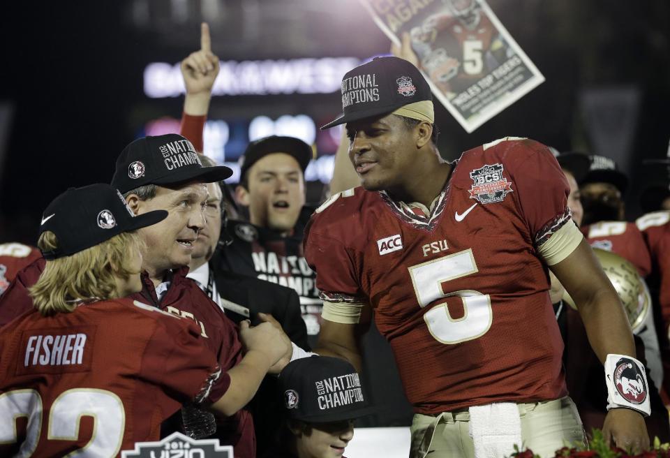 Florida State head coach Jimbo Fisher and Jameis Winston (5) celebrate after the NCAA BCS National Championship college football game against Auburn Monday, Jan. 6, 2014, in Pasadena, Calif. Florida State won 34-31. (AP Photo/David J. Phillip)