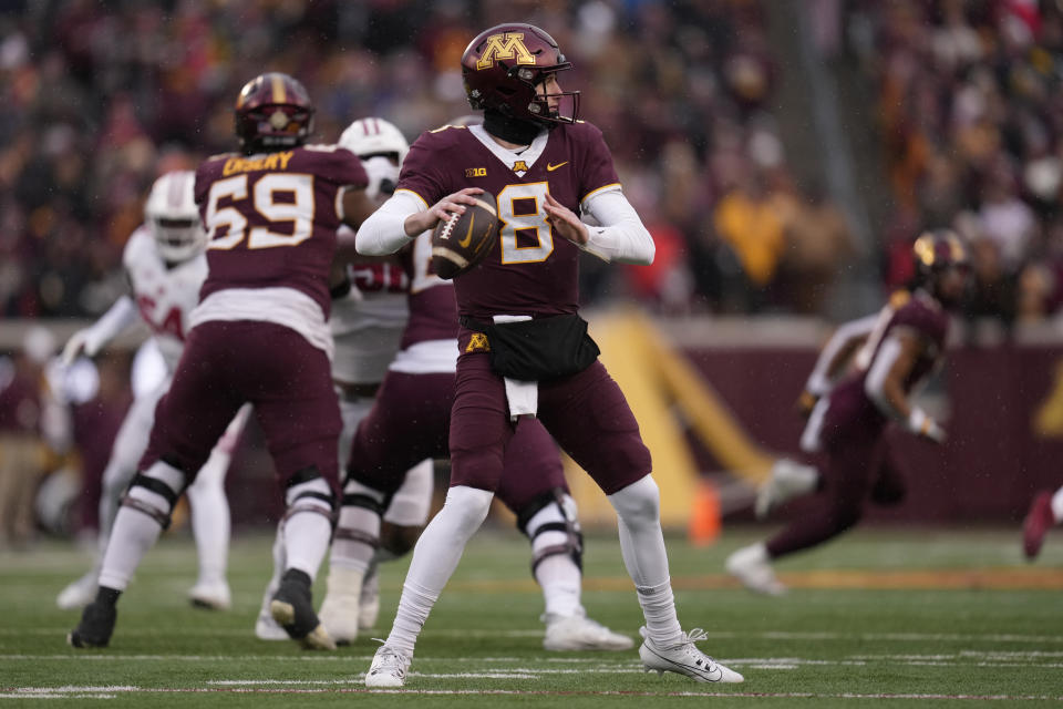 Minnesota quarterback Athan Kaliakmanis (8) looks to pass during the first half of an NCAA college football game against Wisconsin, Saturday, Nov. 25, 2023, in Minneapolis. (AP Photo/Abbie Parr)