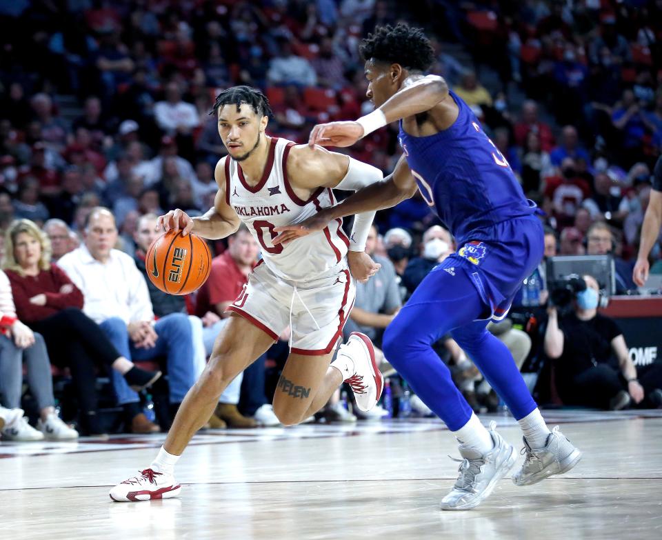 OU's Jordan Goldwire (0) drives to the basket against Kansas' Ochai Agbaji (30) on Tuesday in Norman.