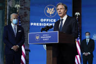 President-elect Joe Biden listens as his Secretary of State nominee Tony Blinken speaks at The Queen theater, Tuesday, Nov. 24, 2020, in Wilmington, Del. Biden’s first wave of Cabinet picks and choices for his White House staff have prized staying power over star power, with a premium placed on government experience and proficiency as he looks to rebuild a depleted and demoralized federal bureaucracy.(AP Photo/Carolyn Kaster)