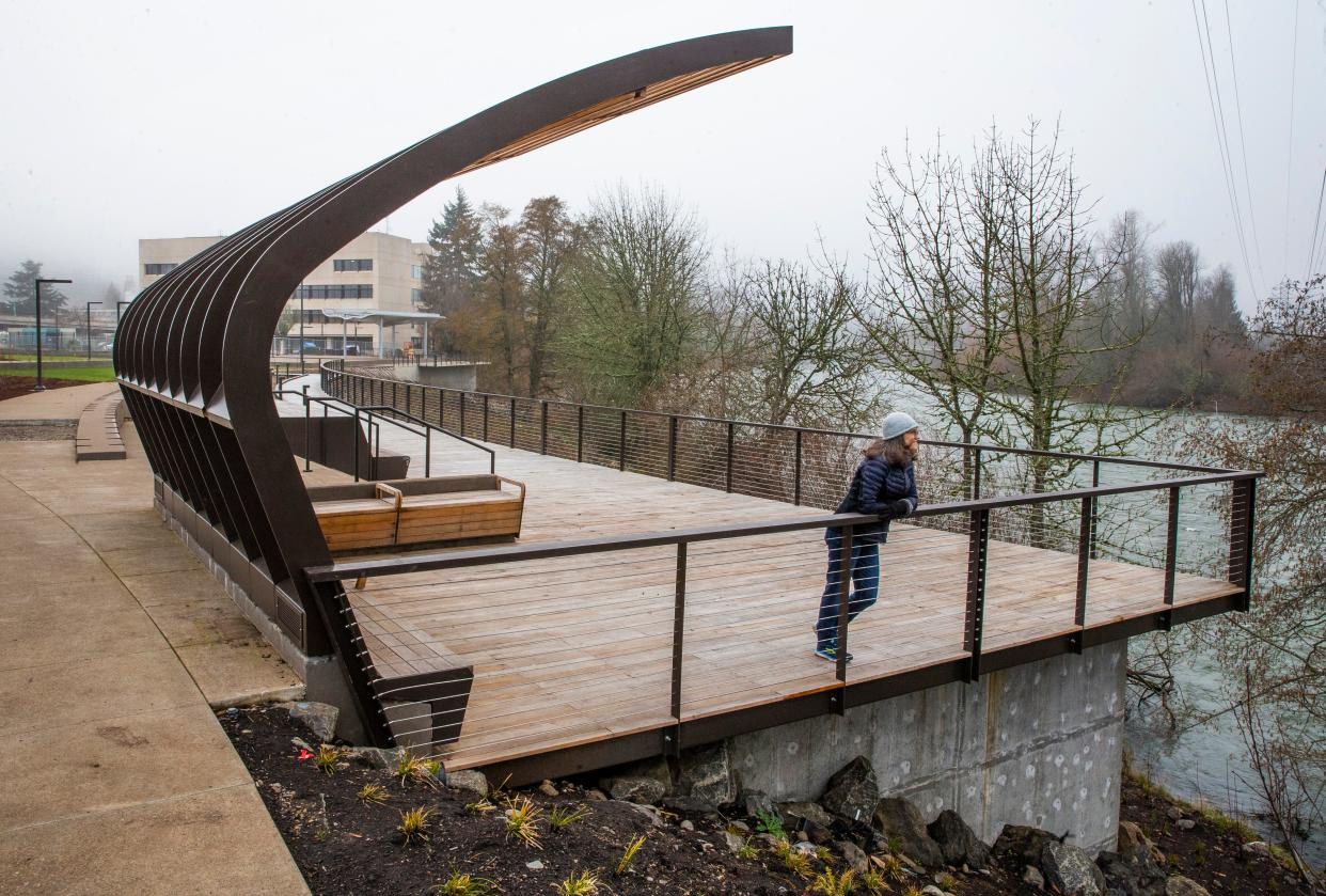 Eugene Parks and Open Space Landscape Architect Emily Proudfoot takes in the view of the Willamette River from the boardwalk as the new Downtown Riverfront Park in Eugene nears completion.