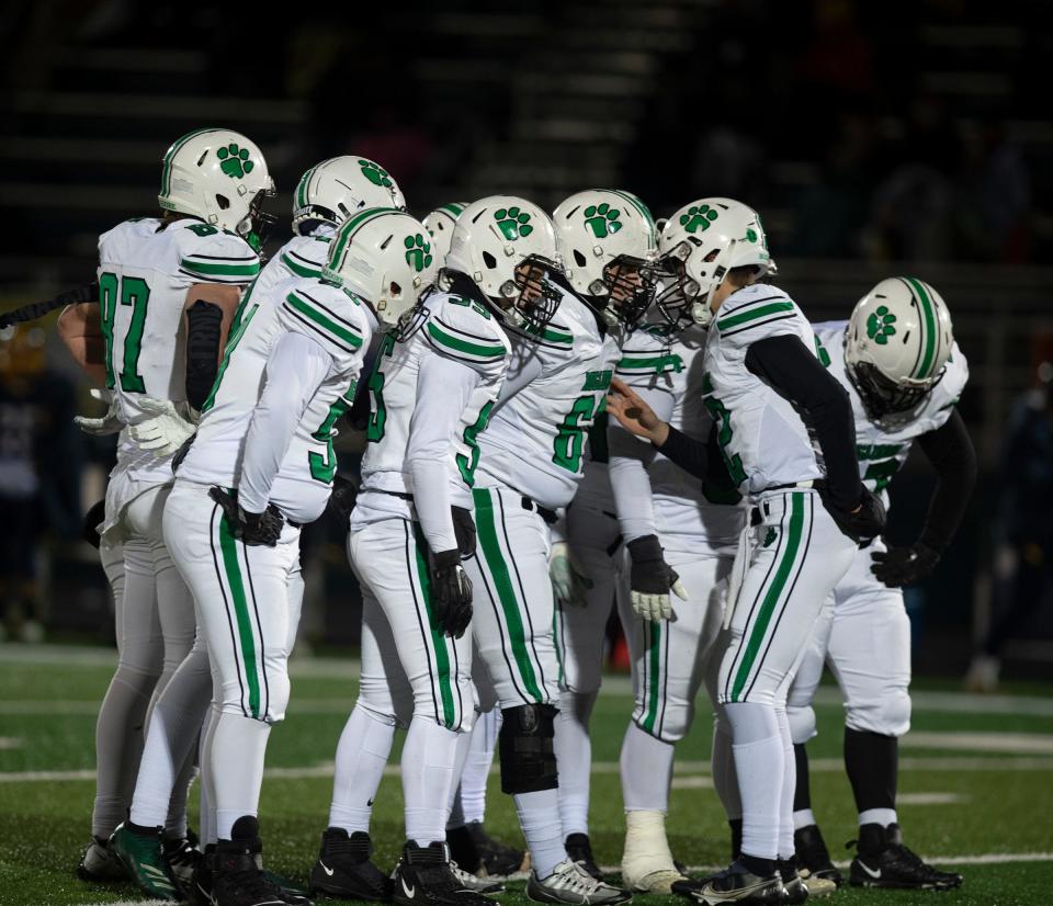 Mogadore quarterback Zeke Cameron talks to his teammates in the huddle against Kirtland in a Region 21 title game.