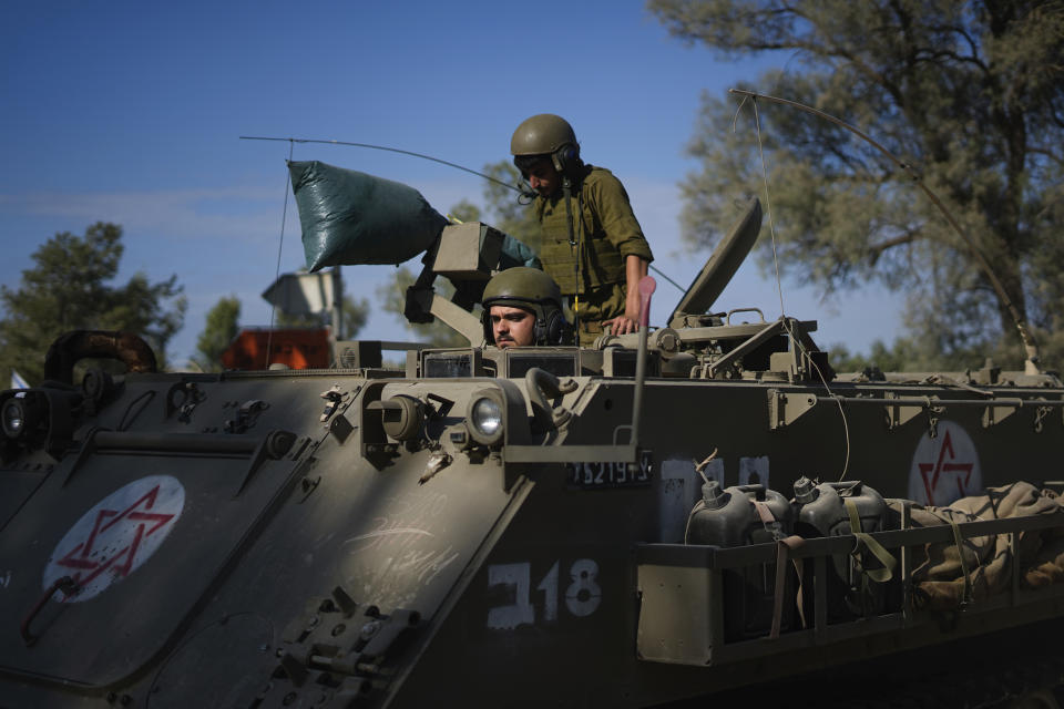 Israeli soldiers gather in a staging area near the border with Gaza Strip, in southern Israel Tuesday, Oct. 17, 2023. (AP Photo/Ariel Schalit)