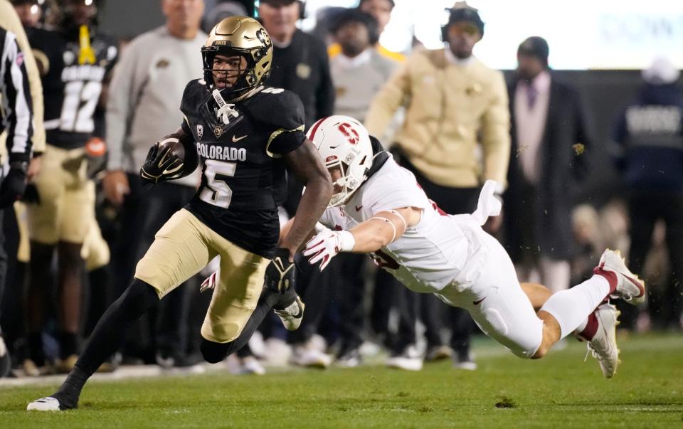 Colorado wide receiver Jimmy Horn Jr., front, eludes Stanford linebacker Spencer Jorgensen during the first half of an NCAA college football game Friday, Oct. 13, 2023, in Boulder, Colo.