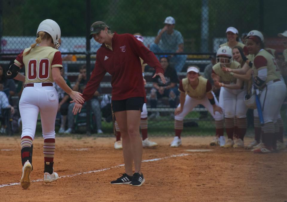 Florida High head coach Brittany Gilliam high fives junior infielder Madelyn Mayo after a home run in a game against Suwanee on March 22, 2022, at Florida High. The Seminoles won 10-0.