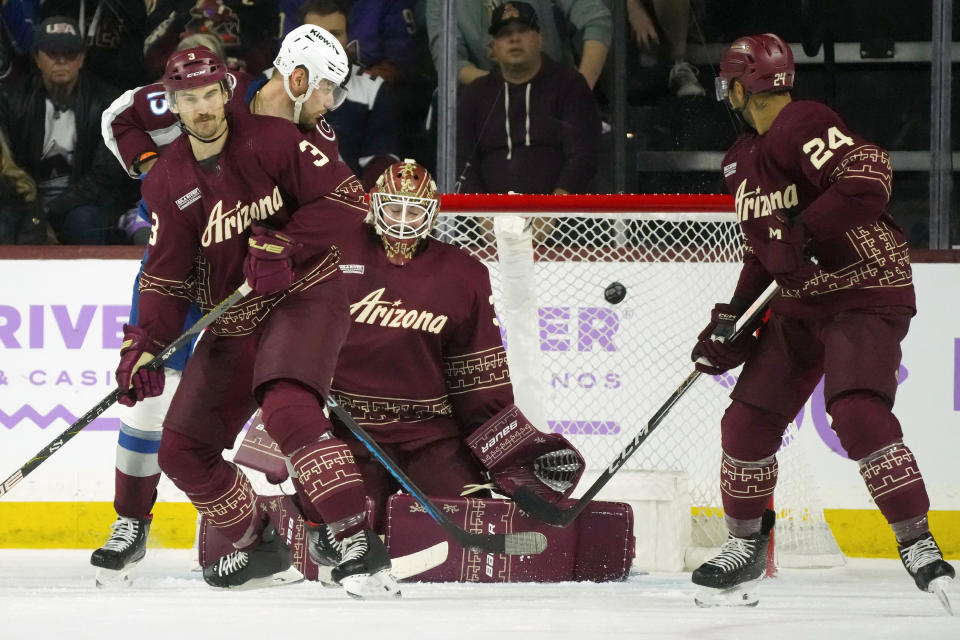 Arizona Coyotes goaltender Connor Ingram, second from right, gives up a goal to Colorado Avalanche' Cale Makar as the puck gets past Coyotes defensemen Matt Dumba (24) and Josh Brown (3) and Avalanche right wing Valeri Nichushkin, left, during the first period of an NHL hockey game Thursday, Nov. 30, 2023, in Tempe, Ariz. (AP Photo/Ross D. Franklin)