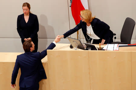 Austrian Chancellor Sebastian Kurz shakes hands with the President of Parliament Doris Bures as he leaves a session of the Parliament in Vienna, Austria May 27, 2019. REUTERS/Leonhard Foeger