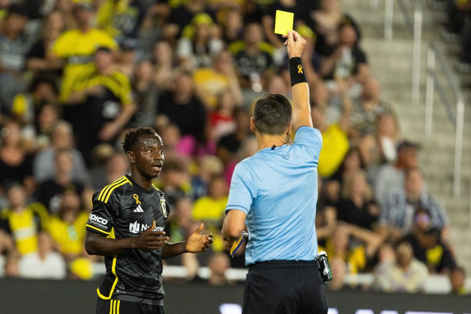 Sep 21, 2024; Columbus, Ohio, USA; Columbus Crew midfielder Yaw Yeboah (14) gets a yellow card for a foul in the box in the second half against Orlando City at Lower.com Field. Mandatory Credit: Trevor Ruszkowski-Imagn Images