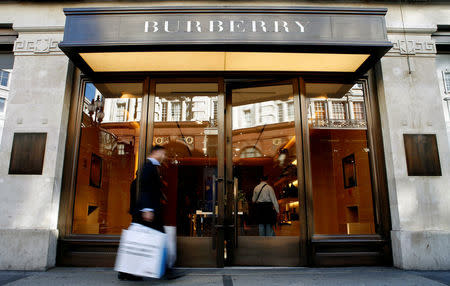 A customer walks in front of a Burberry store in central London July 15, 2008. REUTERS/Alessia Pierdomenico/File Photo