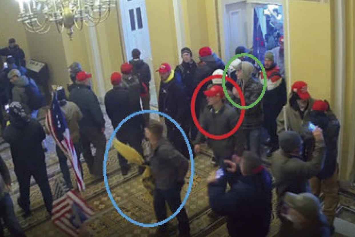 In this image from U.S. Capitol Police video, released and annotated by the Justice Department in the Statement of Facts supporting an arrest warrant, Joshua Abate, circled in green, Micah Coomer, circled in red, and Dodge Dale Hellonen, circled in blue, appear inside the U.S. Capitol on Jan. 6, 2021, in Washington.