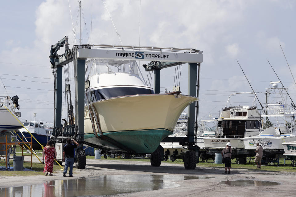 A large boat is moved to a storage lot on dry land at a marina in Cape Canaveral, Fla. as boat owners prepare for the arrival of Hurricane Dorian Saturday, Aug. 31, 2019, The latest forecast says Dorian is expected to stay just off shore of Florida and skirt the coast of Georgia, with the possibility of landfall still a threat on Wednesday, and then continuing up to South Carolina early Thursday. (AP Photo/John Raoux)