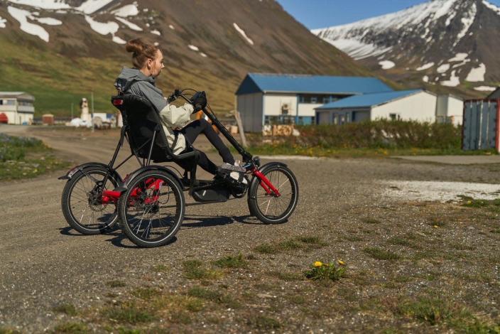 Katrin Bjork Guojonsdottir rides her bike through the small Icelandic town where she lives