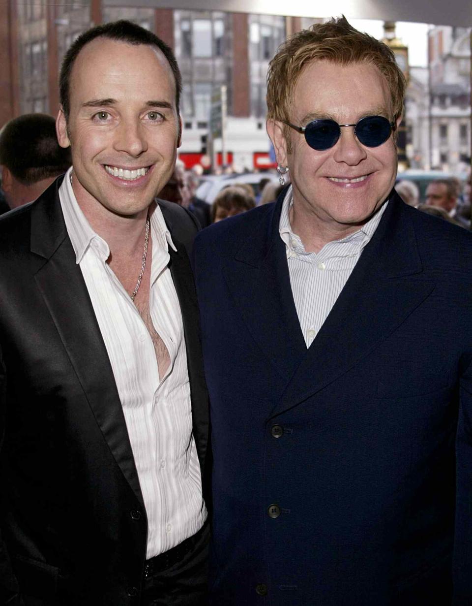 Elton John and David Furnish arrive at the Opening Night and World Premiere of "Billy Elliot: The Musical" at the Victoria Palace Theatre on May 12, 2005 in London