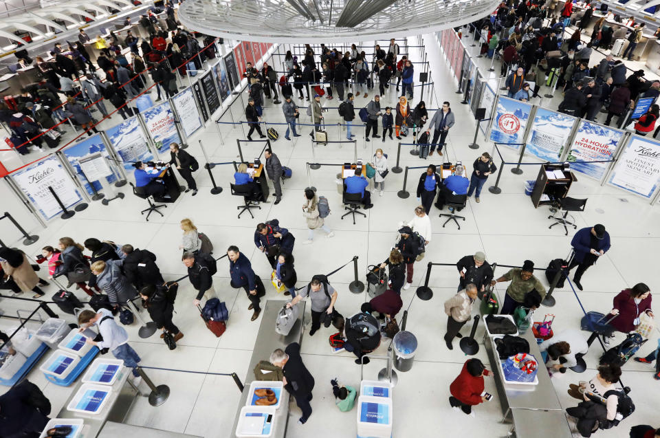 Travelers line up for a security checkpoint at John F. Kennedy International Airport, Wednesday, Nov. 21, 2018, in New York. The airline industry trade group Airlines for America expects that Wednesday will be the second busiest day of the holiday period behind only Sunday, when many travelers will be returning home after Thanksgiving. (AP Photo/Mark Lennihan)