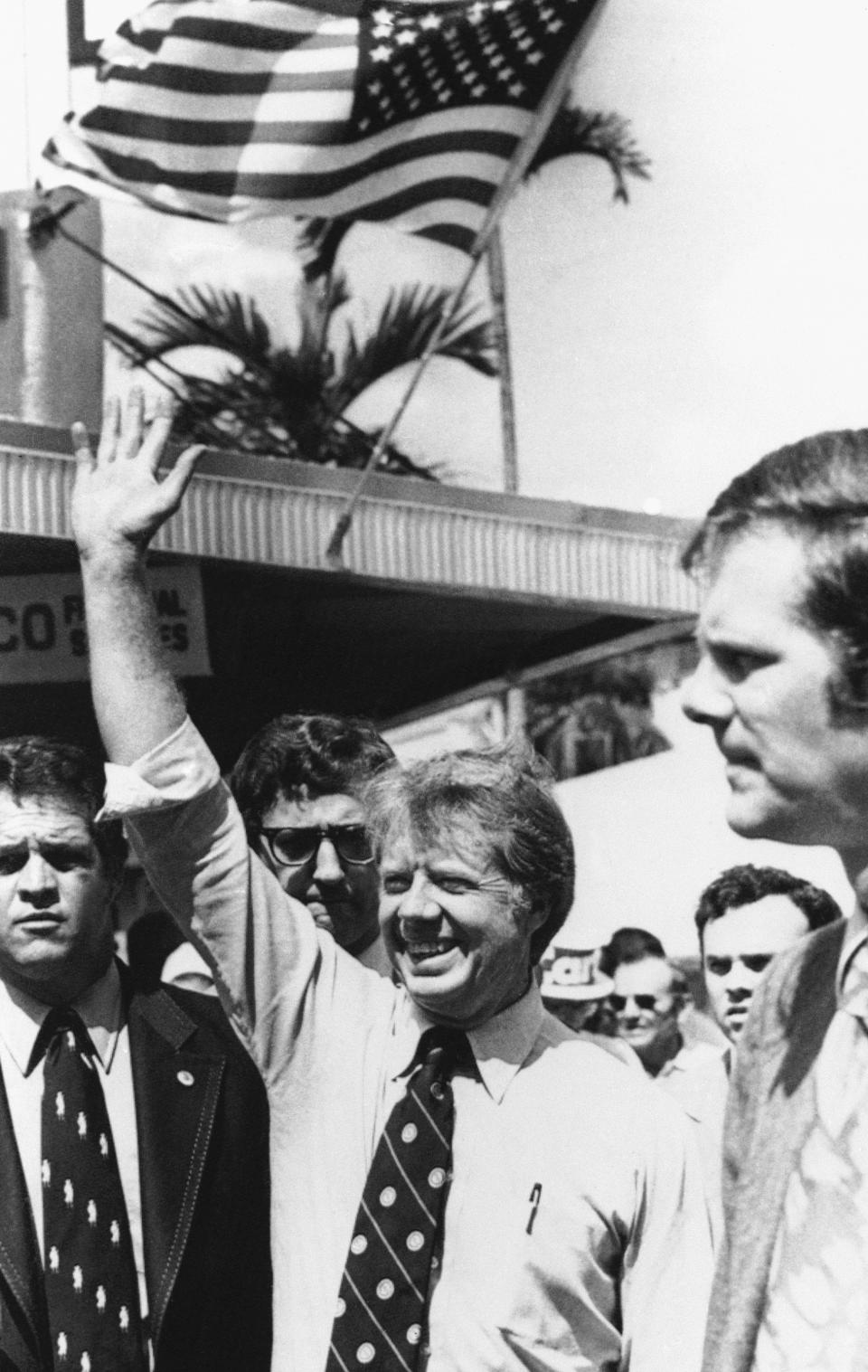 FILE - Democratic presidential candidate Jimmy Carter greets supporters in downtown Fort Myers, Fla., as he makes his presidential campaign swing through Florida, March 2, 1976. Carter announced his campaign for the presidency in December 1974. At that point he had never met an American president. He later said part of what nudged him into the race was meeting several candidates ahead of the 1972 campaign and concluding that he was talented as they were. (AP Photo, File)