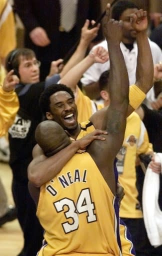 Kobe Bryant jumps into the arms of Shaquille O'Neal (34) as the Los Angeles Lakers celebrate winning the 2000 NBA Finals
