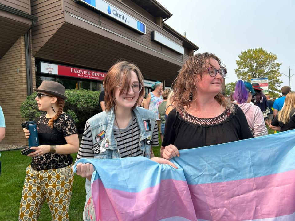 Wilbur Braidek, left, attended Sunday's rally with his mother Jessica Fraser, right. Braidek changed his name at school last year without telling his parents.