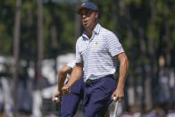 Justin Thomas reacts to his putt on the fifth green during their fourball match at the Presidents Cup golf tournament at the Quail Hollow Club, Friday, Sept. 23, 2022, in Charlotte, N.C. (AP Photo/Julio Cortez)