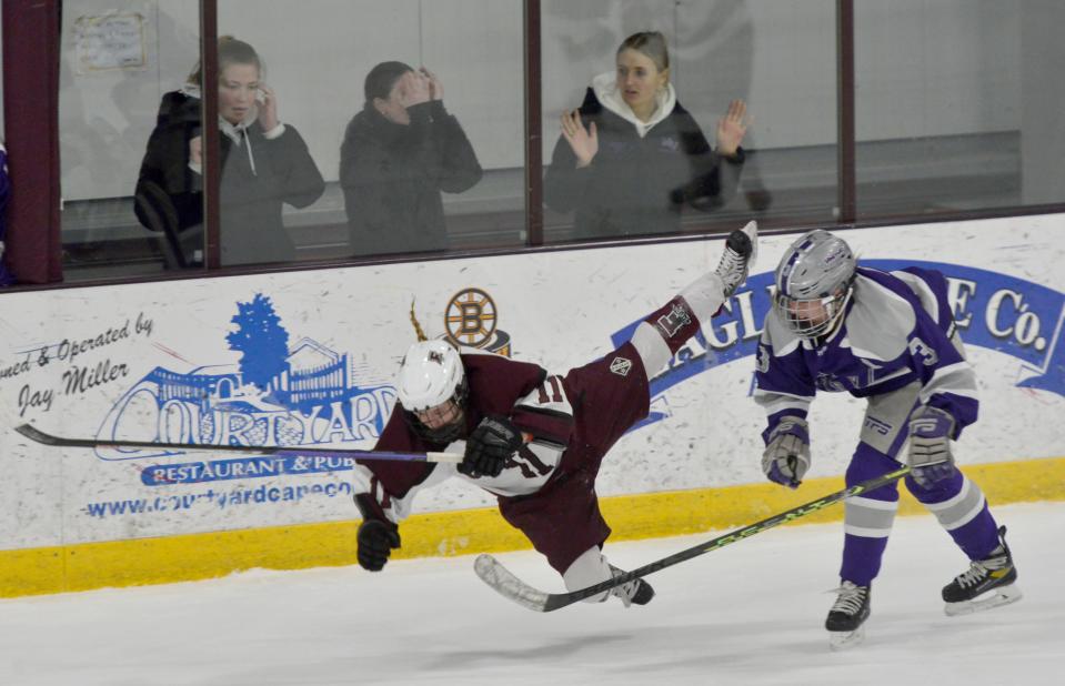 FALMOUTH -- 02/08/23 -- Falmouth's Casey Roth, left, goes airborne after being checked by Martha's Vineyard's Marin Gillis in second period action. 
Falmouth High School hosted Martha's Vineyard Regional High School in girls hockey action Wednesday at Falmouth Ice Arena.