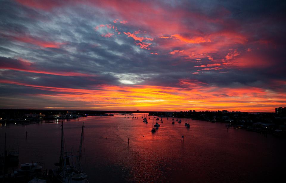 Fort Myers Beach is awash in color just before sunrise on the mooring field on Matanzas Pass on Monday, Nov.16, 2021.  