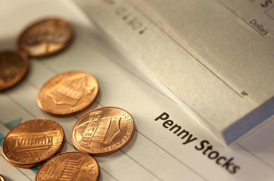 Pennies laid out across a form that reads "penny stocks."