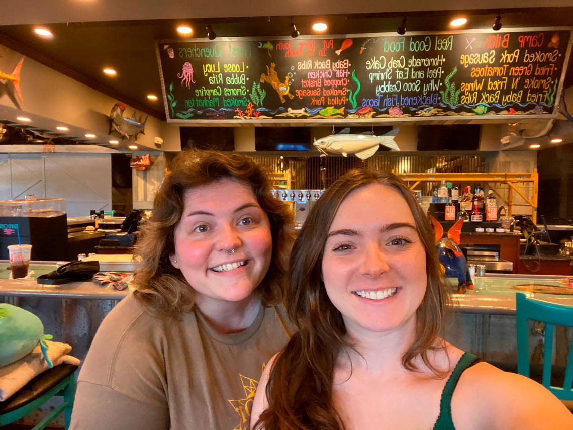 Candice Regan (left) and Ramsey Diven completed the commissioned chalk mural above the bar at Bubba’s Fish Camp and Smokehouse in Myrtle Beach, S.C. in two days. The friends graduated from Coastal Carolina University in 2020. Photo courtesy Candice Regan.
