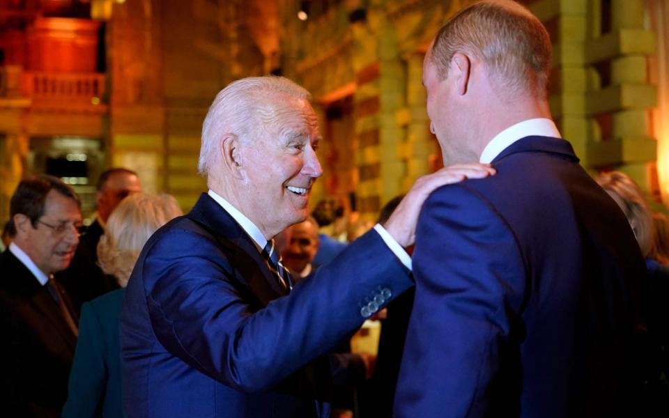 US President Joe Biden greets Prince William at a reception to mark the opening day of Cop26 in Glasgow in November 2021 - AFP