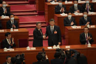 Newly elected Premier Li Qiang, center left, shakes hands with Chinese President Xi Jinping as former Premier Li Keqiang, at right, applauds during a session of China's National People's Congress (NPC) at the Great Hall of the People in Beijing, Saturday, March 11, 2023. (AP Photo/Mark Schiefelbein)