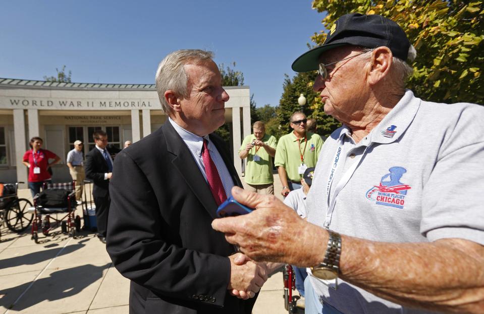 U.S. Senator Dick Durbin (D-IL) (L) shakes hands with veteran Jack Moran of the Chicago Honor Flight at the World War Two Memorial in Washington October 2, 2013. The memorial is technically closed due to the government shutdown, but was opened today and yesterday for visiting veteran groups REUTERS/Kevin Lamarque (UNITED STATES - Tags: POLITICS BUSINESS)