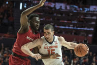 Illinois' Giorgi Bezhanishvili (15) tries to power past Rutgers' Shaq Carter (13) in the first half of an NCAA college basketball game, Sunday, Jan. 11, 2020, in Champaign, Ill. (AP Photo/Holly Hart)