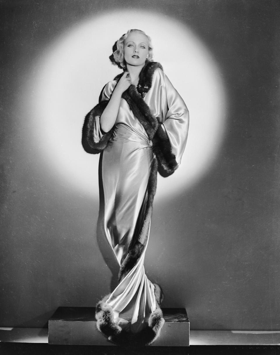 Lombard wears a long silk robe, circa 1932.