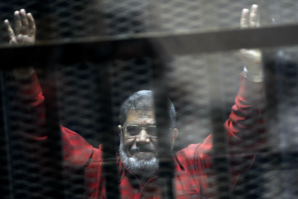 Former Egyptian president Mohammed Morsi wearing a red jumpsuit in a makeshift courtroom in 2015