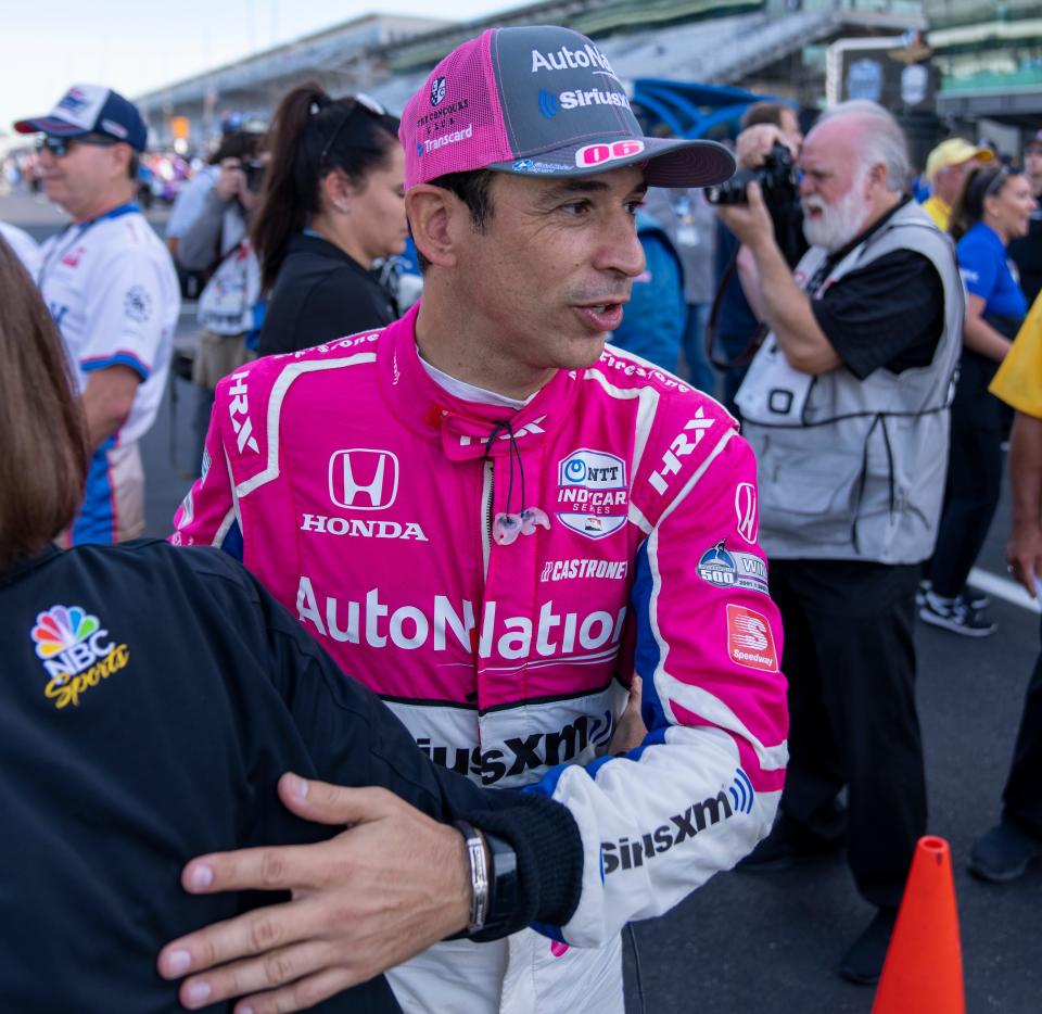 Helio Castroneves gets a hug at the Indianapolis Motor Speedway, Saturday, July 30, 2022, during an event to honor past IndyCar and NASCAR winners at this track. 