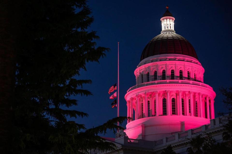 The Capitol dome is lit pink in California after the U.S. Supreme Court’s decision on Dobbs v. Jackson earlier in the day Friday, June 24, 2022, effectively overturning Roe v. Wade. Planned Parenthood Advocates Mar Monte planned a vigil outside the Capitol, which drew a diverse range of activists supporting women’s reproductive rights who later marched through downtown Sacramento.