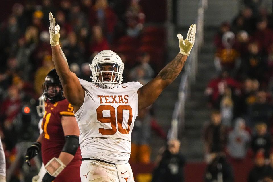 Texas Longhorns defensive lineman Byron Murphy II (90) celebrates sacking Iowa State quarterback Rocco Becht (3) during the game at Jack Trice Stadium on Saturday, Nov. 8, 2023 in Ames, Iowa.