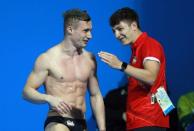 Diving - Gold Coast 2018 Commonwealth Games - Men’s 1m Springboard Final - Optus Aquatic Centre - Gold Coast, Australia - April 11, 2018. Jack Laugher of England celebrates with his teammate after winning the gold medal. REUTERS/Athit Perawongmetha