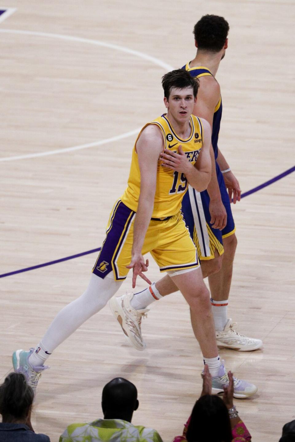 Lakers guard Austin Reaves celebrates with the "freeze" pose after making a three-point shot.