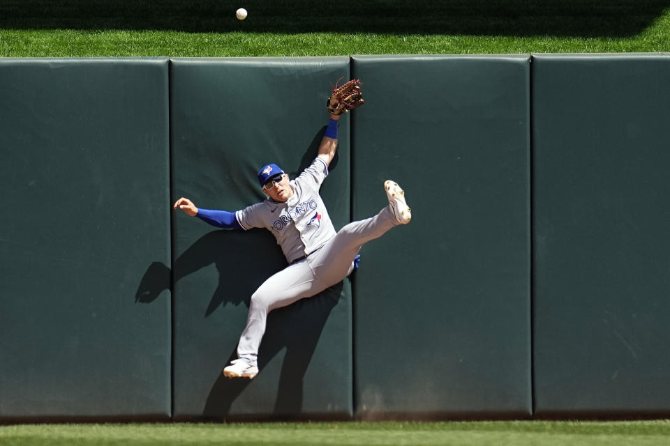 Toronto Blue Jays center fielder Daulton Varsho cannot make the play for a two-run home run by Minnesota Twins' Willi Castro during the fifth inning of a baseball game Saturday, May 27, 2023, in Minneapolis. (AP Photo/Abbie Parr)
