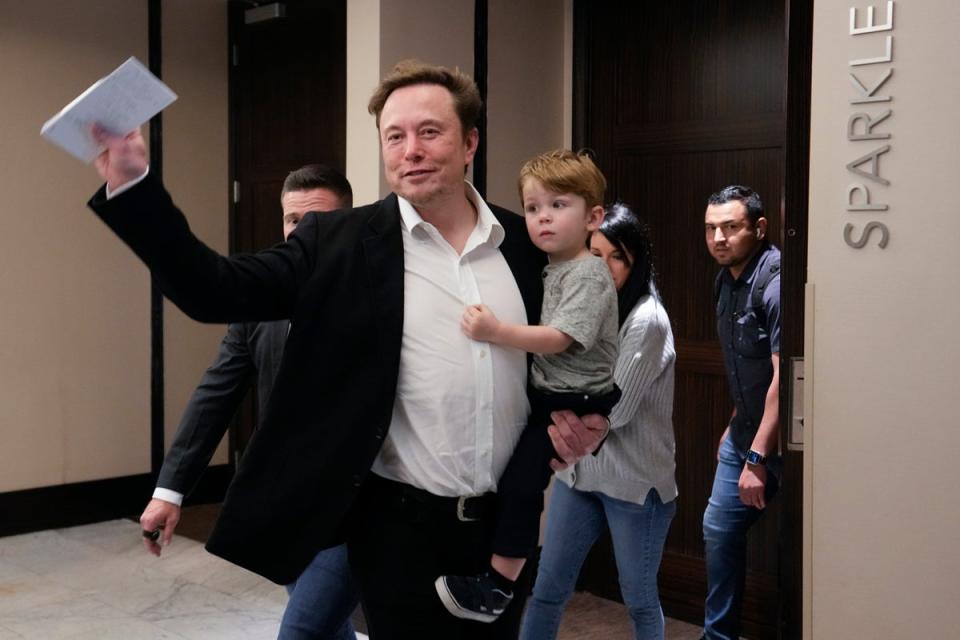 Musk pictured with his young son X AE A-XII (AP)