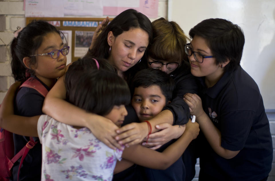 In this Dec.12, 2018 photo, transgender children embrace teacher Teani Cortes during the last day of school at the Amaranta Gomez school in Santiago, Chile. The institution, founded by the Chile-based Selenna Foundation that protects their rights, is a milestone in a socially conservative country. (AP Photo/Esteban Felix)