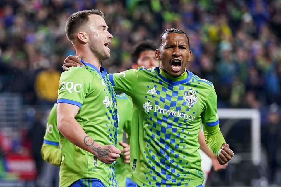 Seattle Sounders midfielder Albert Rusnák, left, celebrates after scoring on a penalty kick against FC Dallas with midfielder Léo Chú, right, during the first half of an MLS playoff soccer match Monday, Oct. 30, 2023, in Seattle. (AP Photo/Lindsey Wasson)