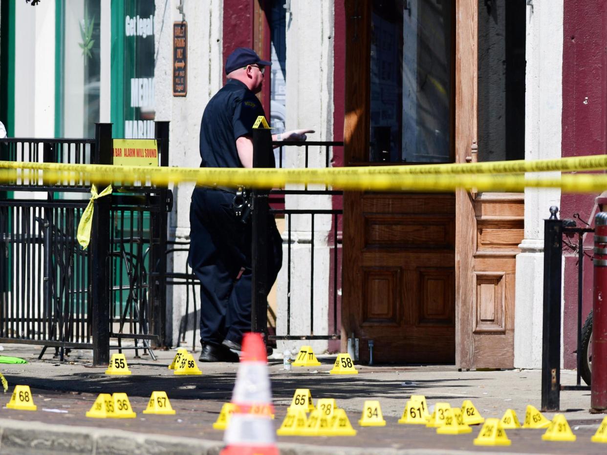 Evidence markers of shell casings line the street at the scene of a shooting in the Oregon District of Dayton, Ohio: (EPA)