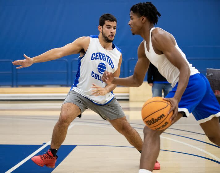 Kade West, left, practices with teammate Malik Johnson at Cerritos College in Norwalk .