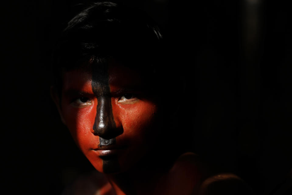 Tenetehara Indigenous Jair Tembe is ready to takes part in a festival at the Alto Rio Guama Indigenous Territory, near the city of Paragominas, state of Para, Brazil, Monday, Sept. 7, 2020. The Indigenous group, also known as Tembe, held a festival this week to celebrate and give thanks that none of their members have fallen ill during the new coronavirus pandemic, after closing their area off in March. (AP Photo/Eraldo Peres)